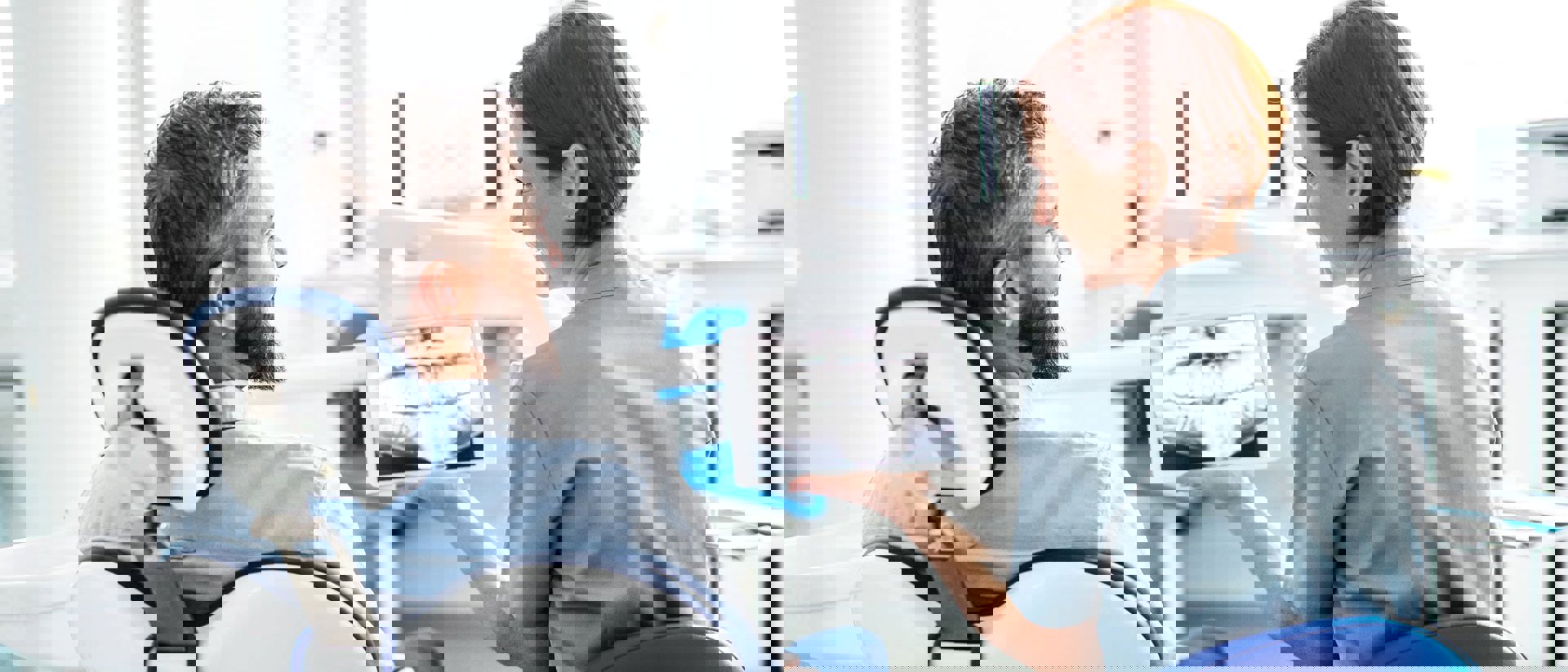 dentist reviews xrays with patient in office